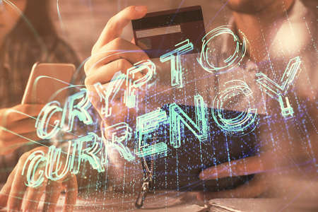 Double exposure of man and woman on-line shopping holding a credit card and crypto theme hologram drawing. Blockchain and E-commerce pay on-line concept.の写真素材