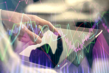 Multi exposure of mans hands holding and using a phone and financial chart drawing. Market analysis...