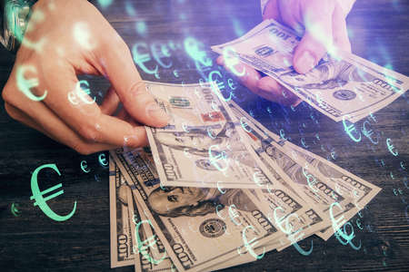 Multi exposure of financial graph drawing hologram and USA dollars bills and man hands. Analysis...