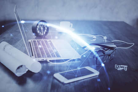 Computer on desktop with social network hologram. Double exposure. Concept of international people...