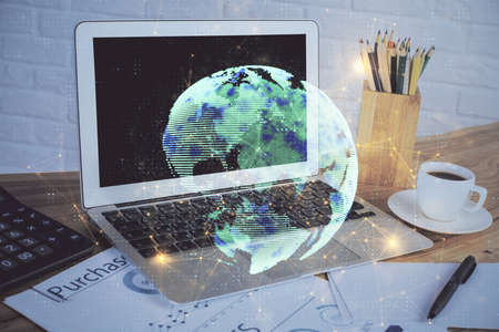 Computer on desktop with social network hologram. Double exposure. Concept of international people...