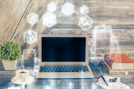 Computer on desktop in office with technology theme hologram. Double exposure. Tech concept.の写真素材