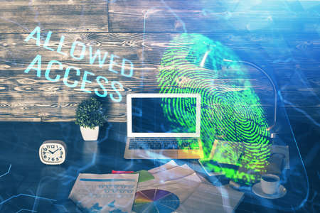 Computer on desktop in office with finger print drawing. Double exposure. Concept of business data...