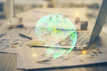 Computer on desktop with social network theme icon. Multi exposure. Concept of international connections.の写真素材