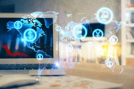 Forex market graph hologram and personal computer on background. Multi exposure. Concept of...