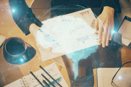 Multi exposure of womans writing hand on background with brain hologram. Concept of brainstorming.