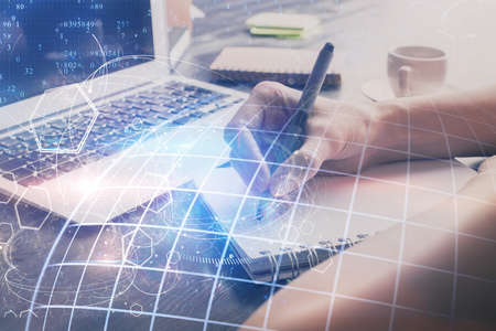 Double exposure of hands making notes with world map hologram and data theme icons. Concept of...