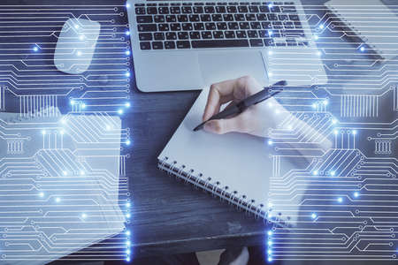 Tech theme hologram over womans hands taking notes background. Concept of hightech. Double exposureの写真素材