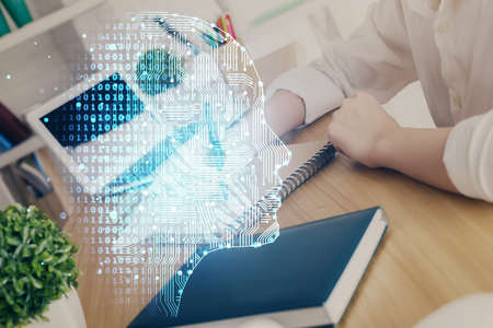 Multi exposure of writing hand on background with brain hologram. Concept of learning.