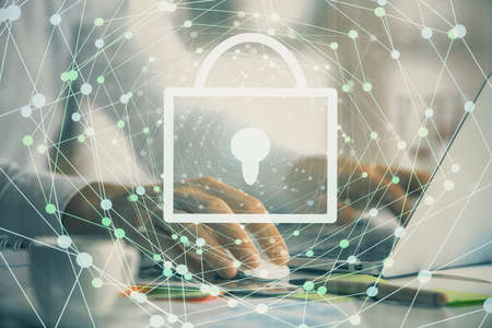Double exposure of lock icon with man working on computer on background. Concept of network...