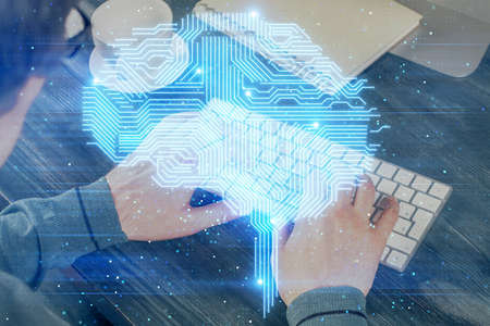 Man with computer background with brain theme hologram. Concept of brainstorm. Double exposure.