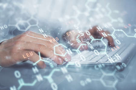 Science formula hologram with man working on computer on background. Education concept. Double exposure.の写真素材