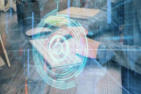 Double exposure of technology hologram with man working on computer background. Concept of big data.の写真素材