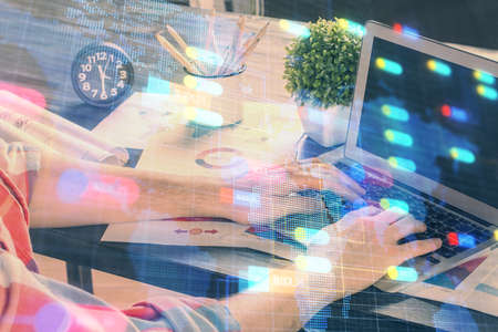 Double exposure of technology hologram with man working on computer background. Concept of big data.の写真素材