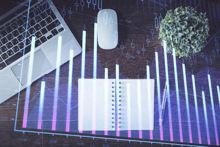 Stock market graph and top view computer on the table background. Double exposure. Concept of...