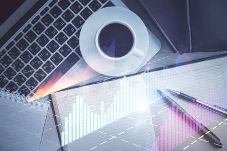 Stock market chart and top view computer on the table background. Double exposure. Concept of financial analysis.の写真素材