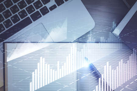 Stock market graph and top view computer on the table background. Multi exposure. Concept of...