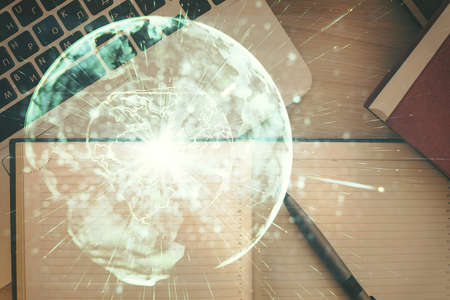Business theme hologram drawings over computer on the desktop background. Top view. Multi exposure. Concept of international connections.の写真素材