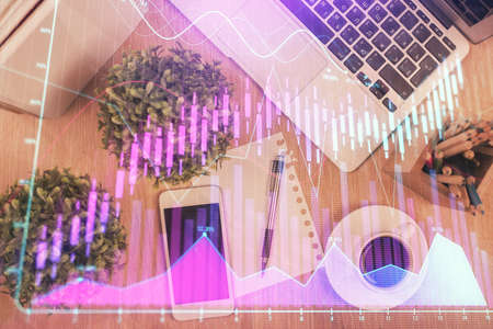 Multi exposure of financial chart hologram over desktop with phone. Top view. Mobile trade platform concept.の写真素材