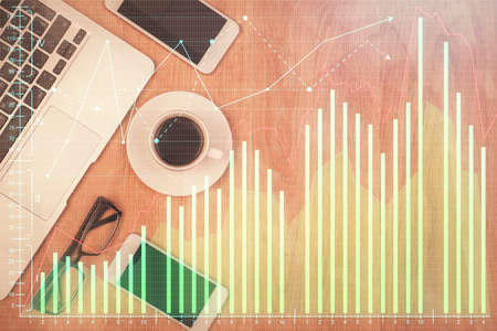 Double exposure of forex chart hologram over desktop with phone. Top view. Mobile trade platform concept.の写真素材
