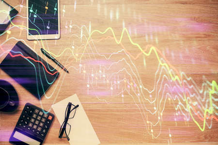 Double exposure of forex graph drawing and work table top veiw. Concept of financial analysis.