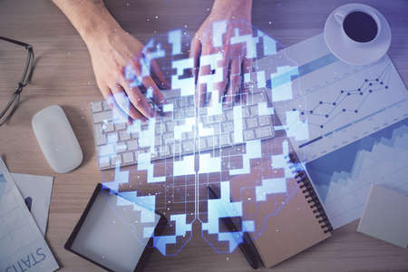 Double exposure of mans hands typing over computer keyboard and data theme hologram drawing. Top...