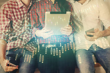 Double exposure of forex graph drawing and man and woman working together holding and using a mobile device. Trade concept.の写真素材