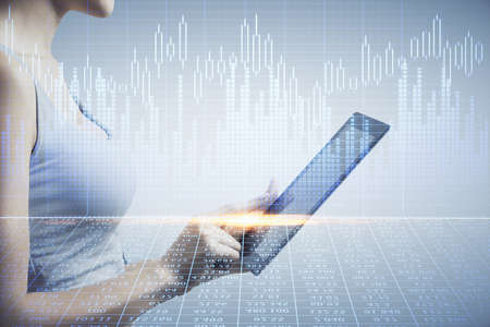 Double exposure of forex chart sketch hologram and woman holding and using a mobile device. Stock...