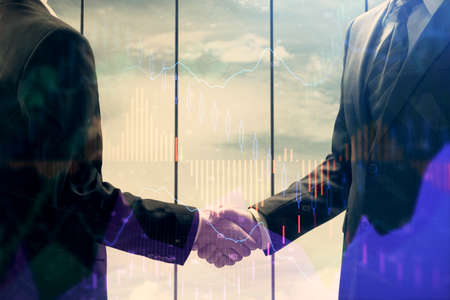 Double exposure of forex graph hologram and handshake of two men. Stock market concept.