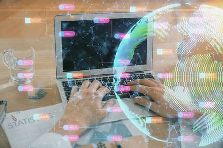 Multi exposure of world map hologram with man working on computer on background. Concept of...