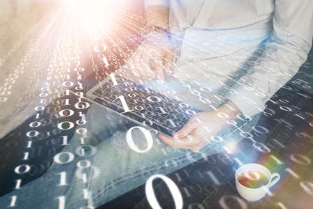 Multi exposure of data internet theme hologram with man working on computer on background. Concept of innovation.の写真素材