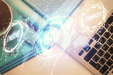 Blockchain theme hologram drawings over computer on the desktop background. Top view. Multi...