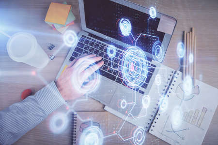 Multi exposure of mans hands typing over computer keyboard and data theme hologram drawing. Top...