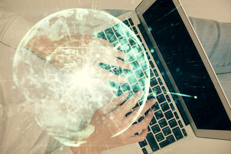 Double exposure of woman hands working on computer and financial theme hologram drawing. Top View....