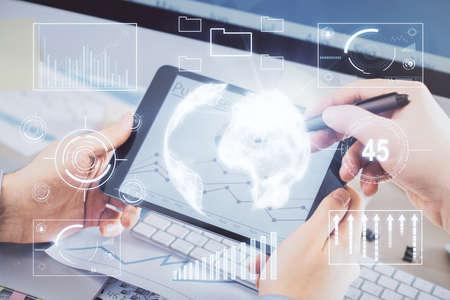 Double exposure of mans hands holding and using a phone and financial chart drawing. Market analysis...