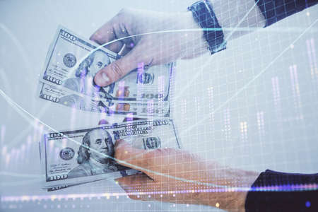 Multi exposure of financial graph drawing hologram and USA dollars bills and man hands. Analysis...