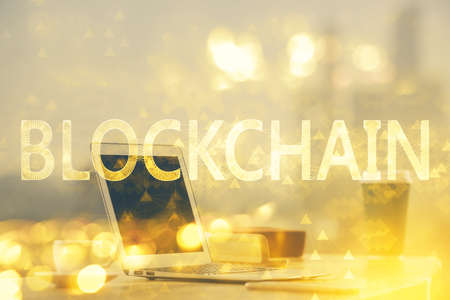 Multi exposure of blockchain theme hologram and table with computer background. Concept of bitcoin...