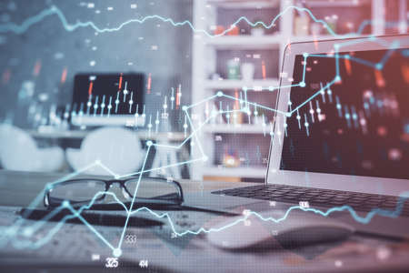 Forex market graph hologram and personal computer on background. Double exposure. Concept of...