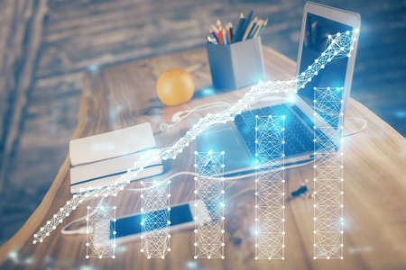 Financial market graph hologram and personal computer on background. Double exposure. Concept of...