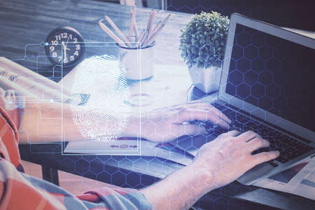 Fingerprint hologram with businessman working on computer on background. Security concept. Double...