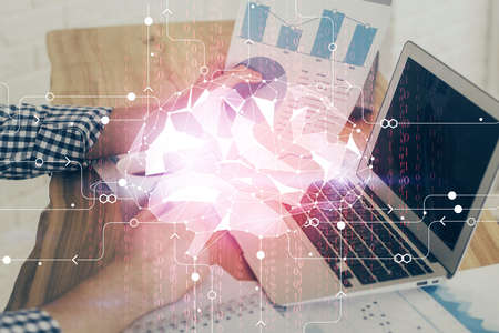 Businessman with computer background with brain theme hologram. Concept of brainstorm. Multi...