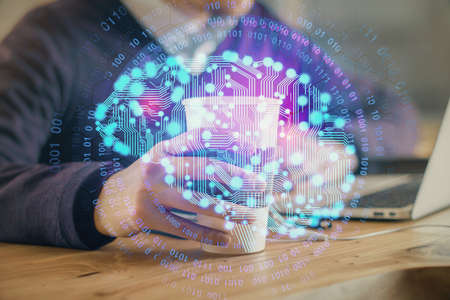 Businessman with computer background with brain theme hologram. Concept of brainstorm. Multi...