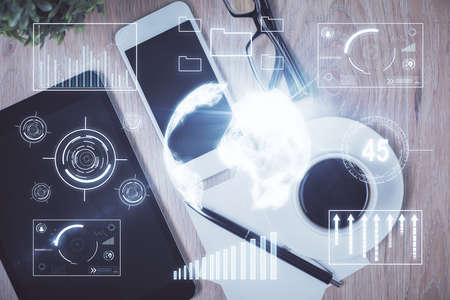 Double exposure of forex chart hologram over desktop with phone. Top view. Mobile trade platform...