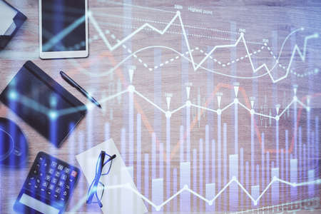 Double exposure of forex graph drawing and work table top veiw. Concept of financial analysis.