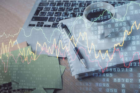 Double exposure of forex chart drawing and desktop with coffee and items on table background....