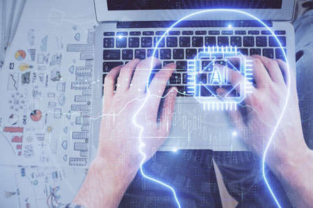 Double exposure of mans hands typing over computer keyboard and brain hologram drawing. Top view. Ai...
