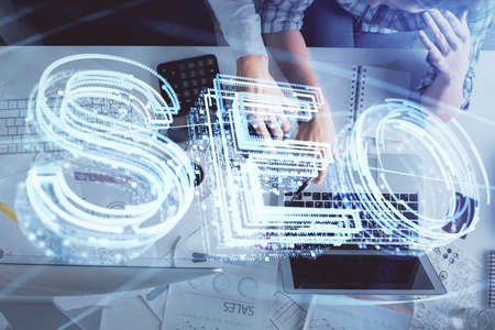 Double exposure of man and woman working together and SEO hologram drawing. Search engine concept....