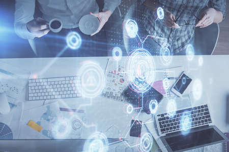 Double exposure of man and woman working together and data theme hologram drawing. Computer...