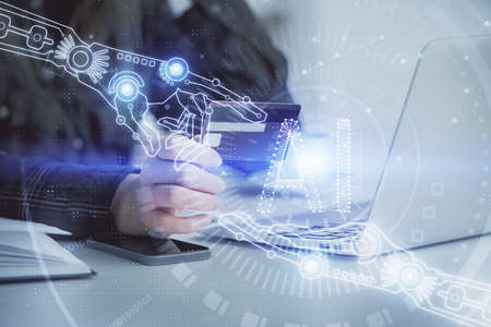 Double exposure of woman on-line shopping holding a credit card and data theme hologram drawing....