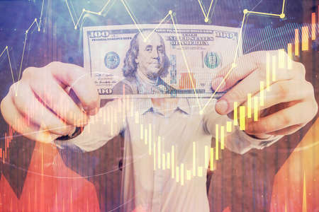 Multi exposure of forex graph drawing hologram and USA dollars bills and man hands. Technical...